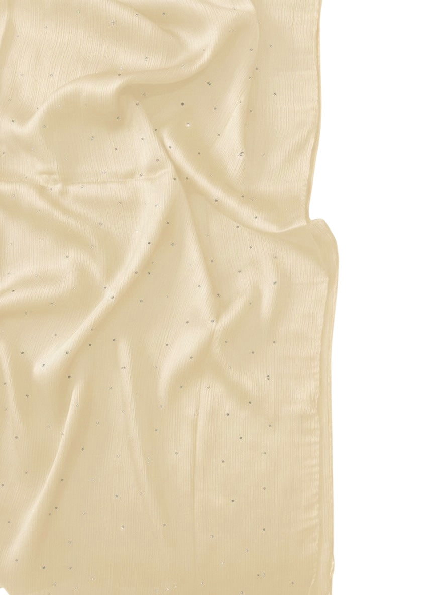 A Luxe Crinkle Silk Hijab in cream, showcasing its textured, flowing fabric draped elegantly.