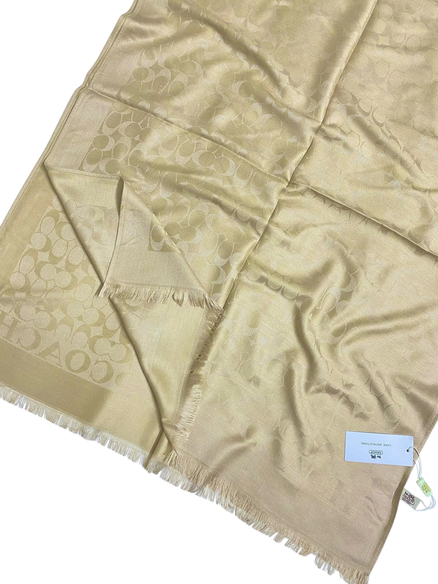 Dull gold branded jacquard hijab with subtle woven pattern.