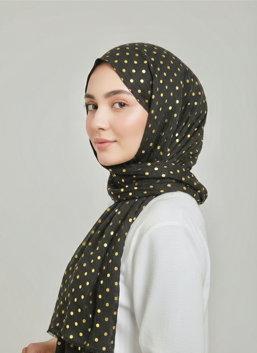 Dapples – Charcoal: A close-up of a charcoal grey fabric with a subtle dappled texture.