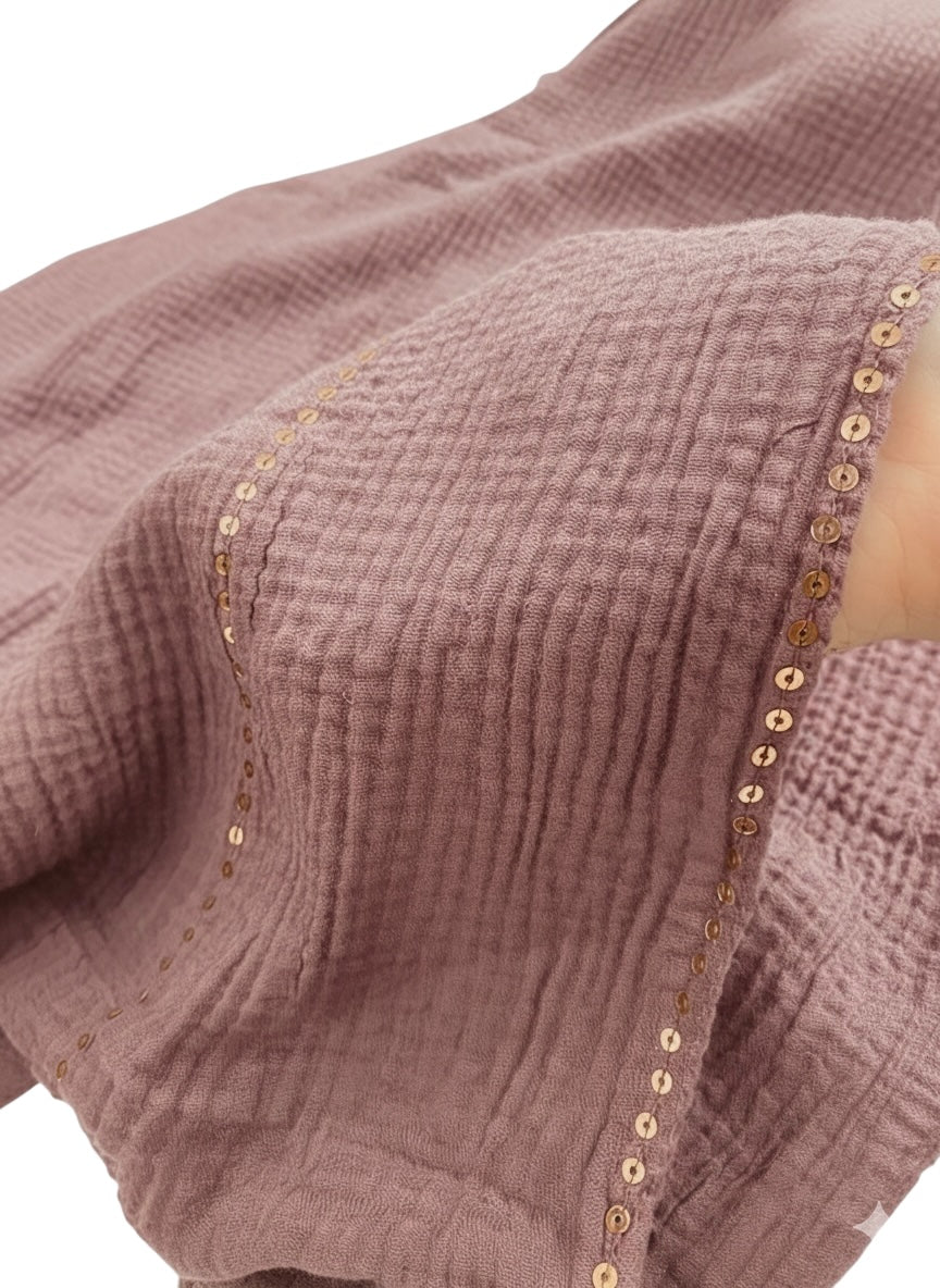A close-up of the Ripple Sequins Hijab XL Size - Opera Mauve, showcasing its shimmering, textured sequin fabric in a rich