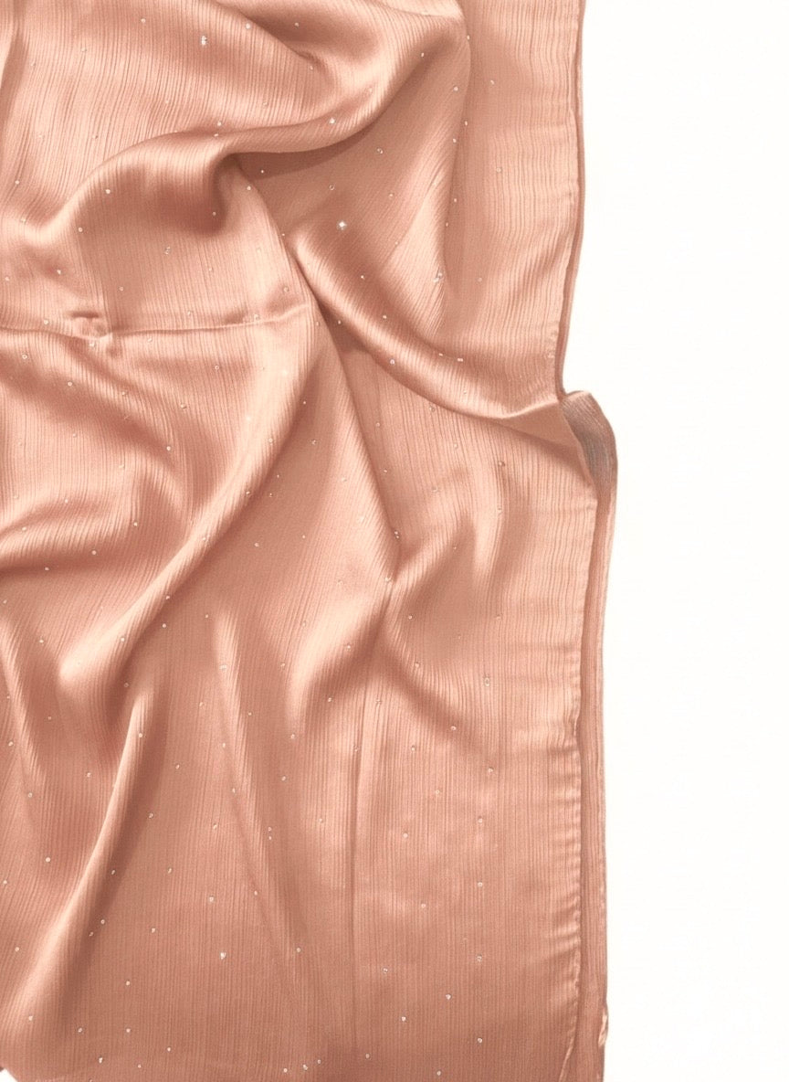 Luxe Crinkle Silk Hijab in Dusty Pink, showcasing its textured fabric and elegant drape.