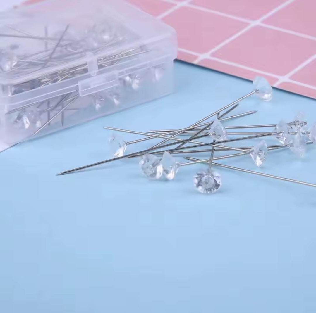 Close-up of a single transparent Crystal Hijab Pin, showcasing its delicate sparkle and smooth finish.